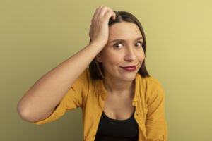 pleased pretty caucasian woman puts hand on forehead isolated on olive green background with copy space